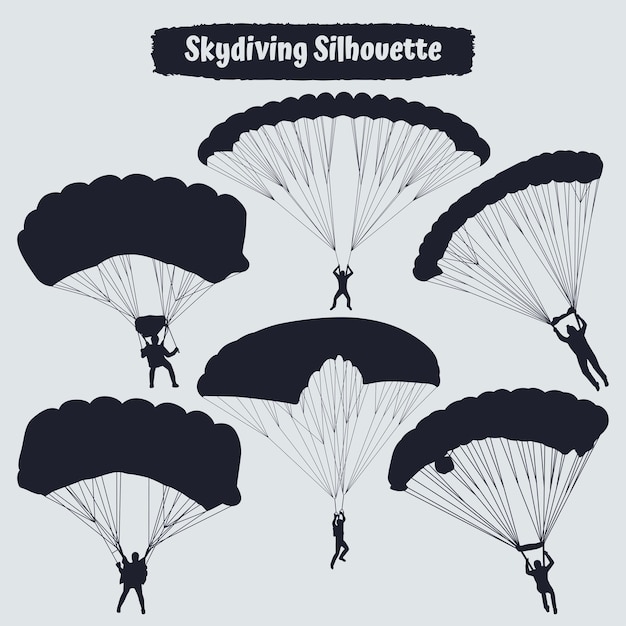 Black silhouettes hang glider or parachute skydiving