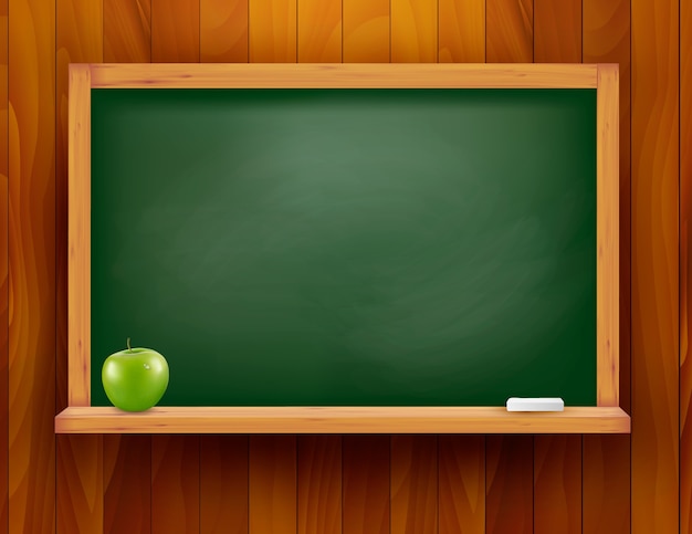 Blackboard with green apple on wooden background.