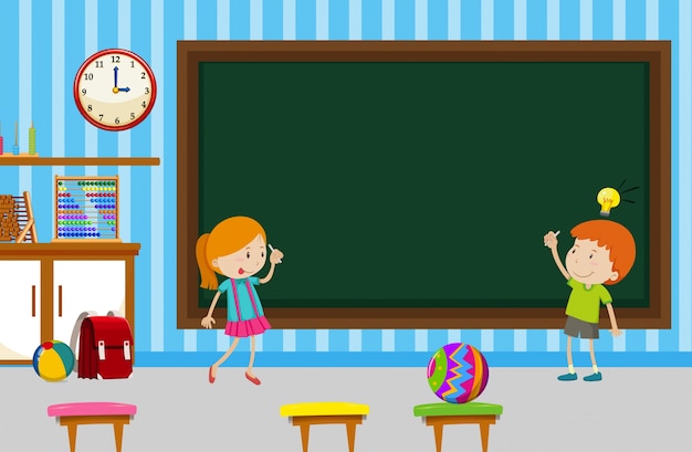 Boy and girl writing on blackboard in classroom