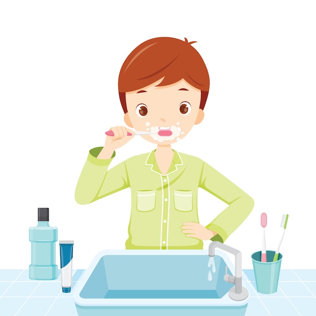 Boy In Pyjamas Brushing His Teeth In Bathroom