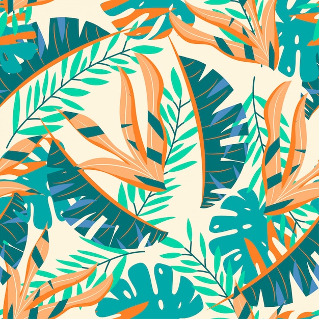 Bright seamless pattern with green and orange tropical leaves