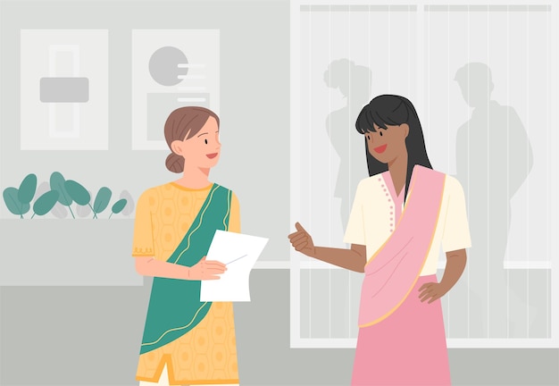 A business woman in traditional Indian attire is having a conversation