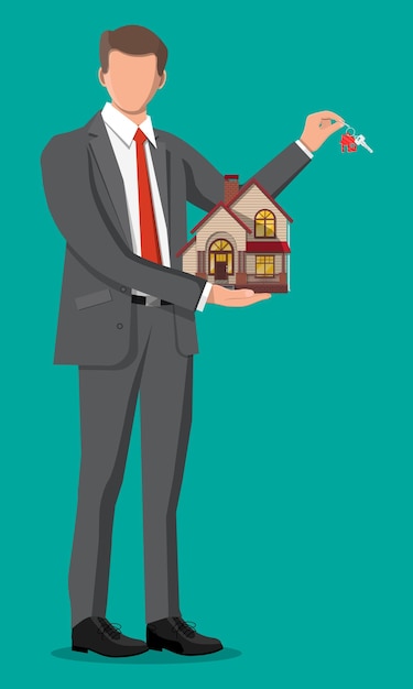 Businessman holding house building and key