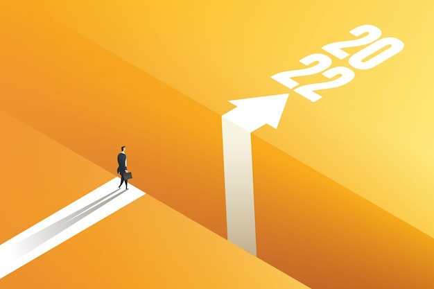 Businessman standing on the edge of the gap with arrows to reach goal 2022