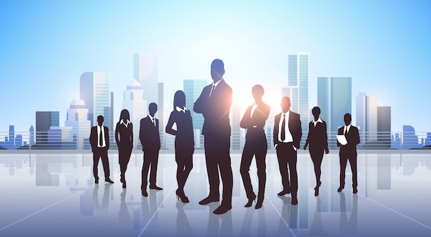 businesspeople silhouette standing over modern city