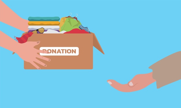 Charity and donating clothes concept. Donation box with clothes. Volunteering and donation concept