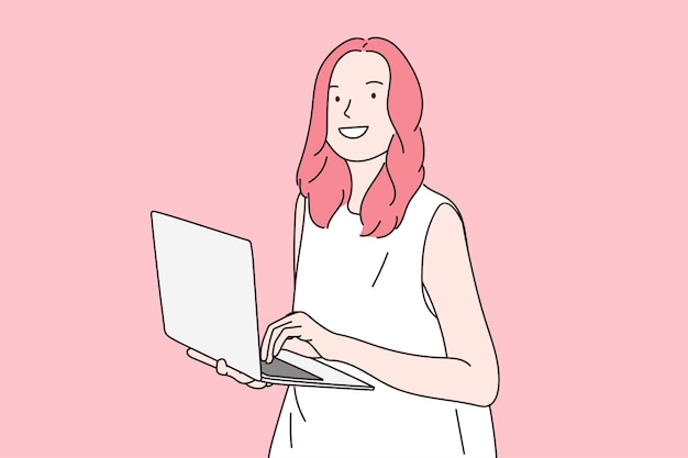 Cheerful young woman standing isolated on pink background using laptop computer Look at the camera