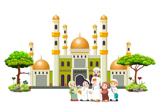 the children with their father are posing in front of the green mosque