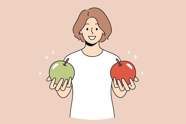 Choosing and getting decision concept Young woman standing and holding green and red apple in hands