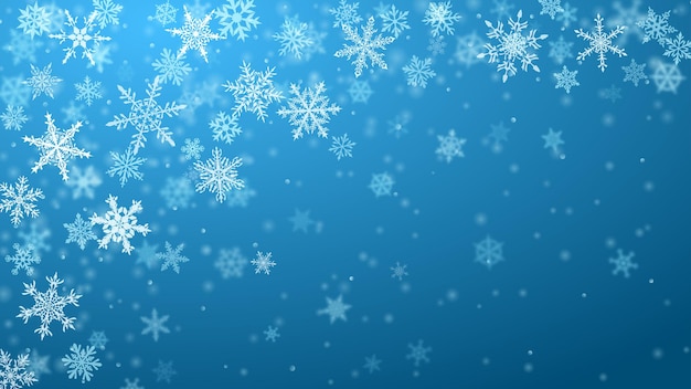 Christmas background of complex blurred and clear falling snowflakes in light blue colors with bokeh effect