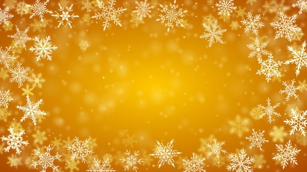 Christmas background of complex blurred and clear falling snowflakes in yellow colors with bokeh effect