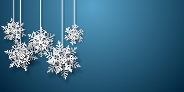 Christmas background of paper snowflakes with soft shadows white on blue background