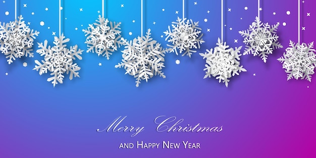 Christmas background of paper snowflakes with soft shadows white on blue and purple background