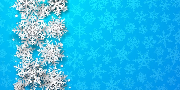 Christmas background of paper snowflakes with soft shadows, white on light blue background with falling snow