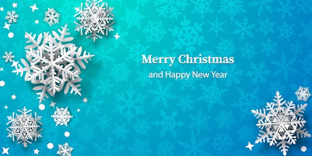 Christmas background of paper snowflakes with soft shadows, white on light blue background with falling snow