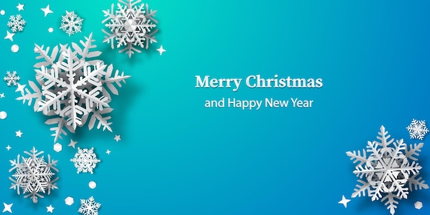 Christmas background of paper snowflakes with soft shadows, white on light blue background