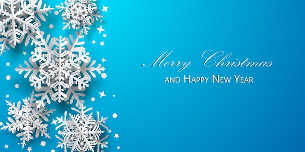 Christmas background of paper snowflakes with soft shadows, white on light blue background