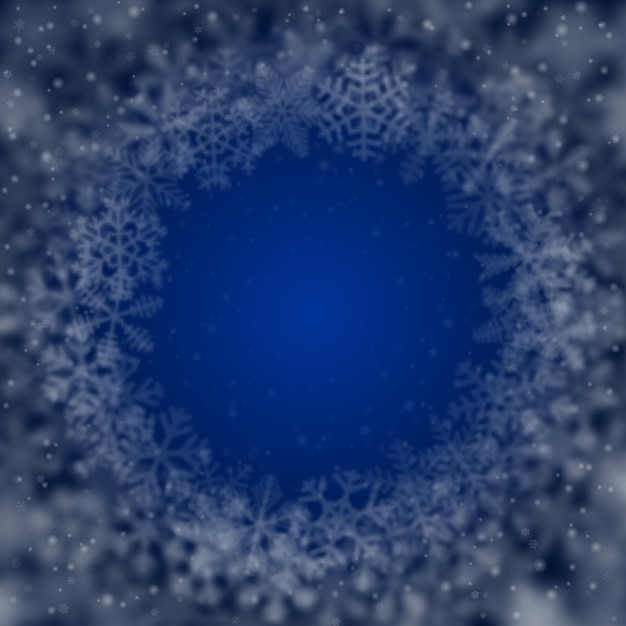 Christmas background of snowflakes of different shape blur and transparency arranged in a circle on blue background