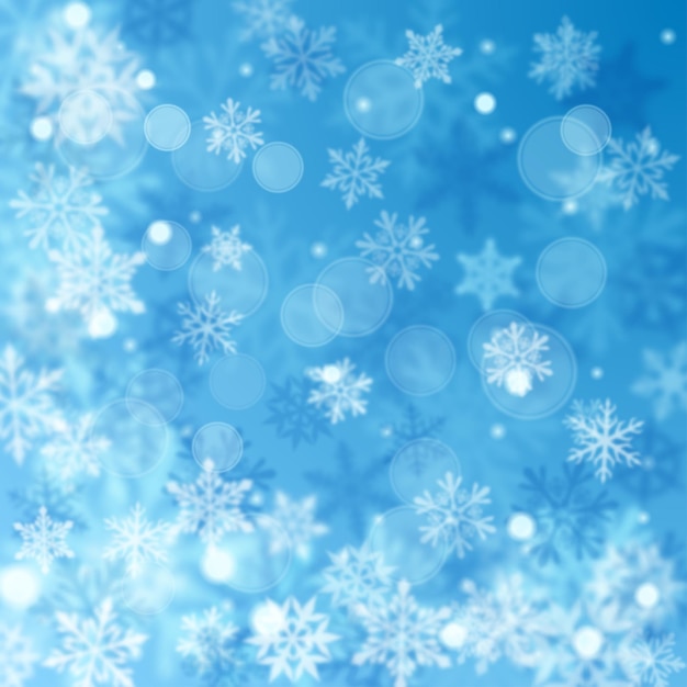 Christmas blurred background of complex defocused big and small falling snowflakes in light blue colors with bokeh effect