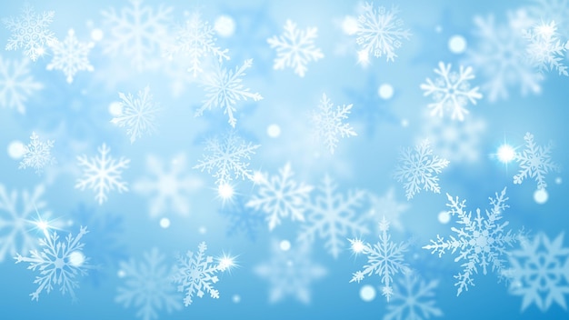 Christmas blurred background of complex defocused big and small falling snowflakes in light blue colors with bokeh effect