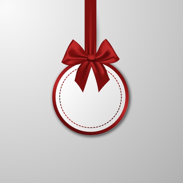 Christmas paper bauble with bow on white.