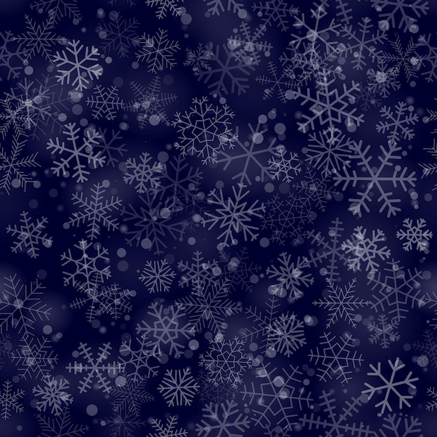 Christmas seamless pattern of snowflakes of different shapes sizes and transparency on dark blue background