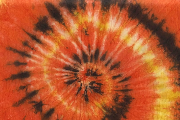 Colorful hand painted watercolor yellow orange spiral tie-dye pattern background