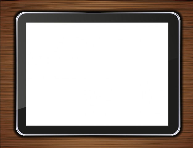 Computer tablet on wooden background.