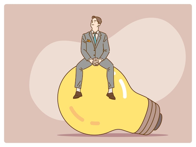 Confident young businessman sitting on top of a bulb