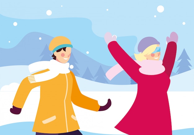 Couple of people with winter clothes in landscape with snowfall