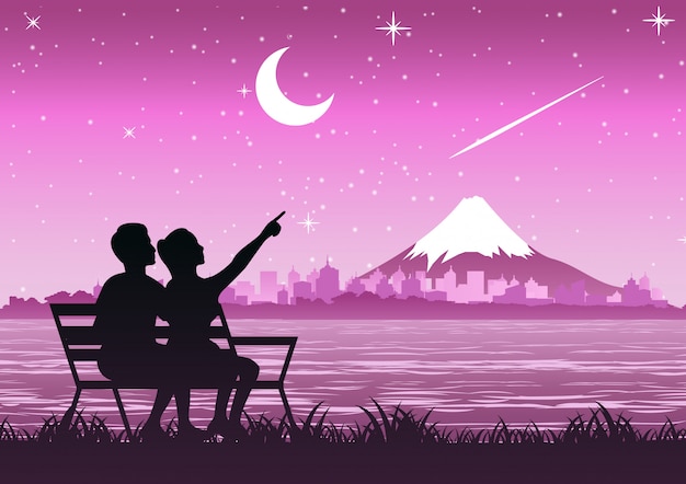 couple sit near Fuji mount to look stars