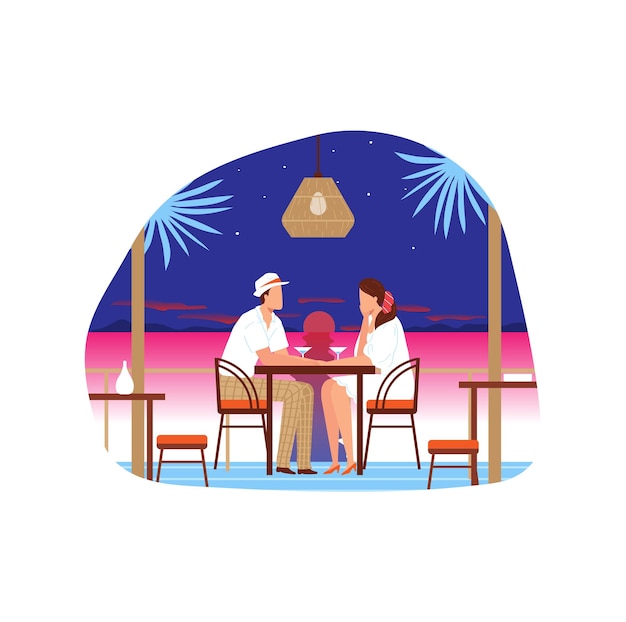 Couple sitting at beach restaurant during sunset romantic dinner with ocean view tropical setting