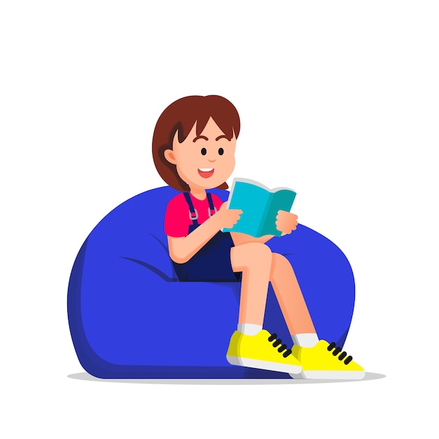 cute boy reading a book and sitting on a beanbag