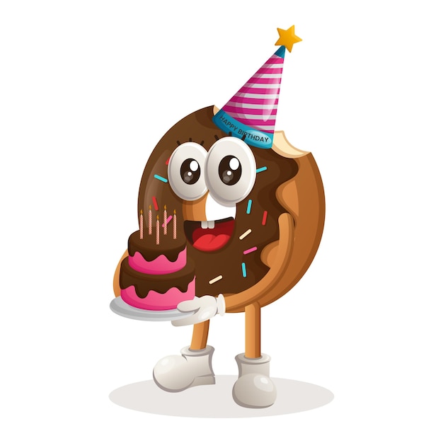 Cute donut mascot wearing a birthday hat holding birthday cake