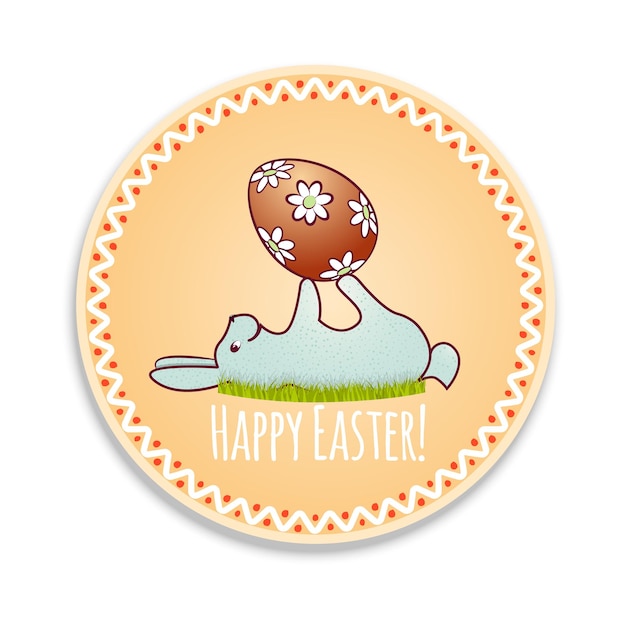 A cute Easter bunny is lying on the green grass and holding a decorated egg on a round banner card