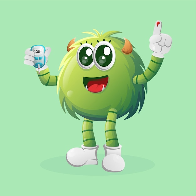 Cute green monster holding a blood glucose meter