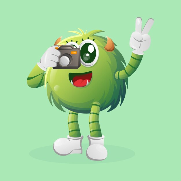 Cute green monster taking photo with camera