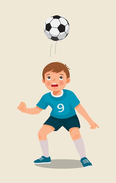 cute little boy playing soccer hitting the football with his head