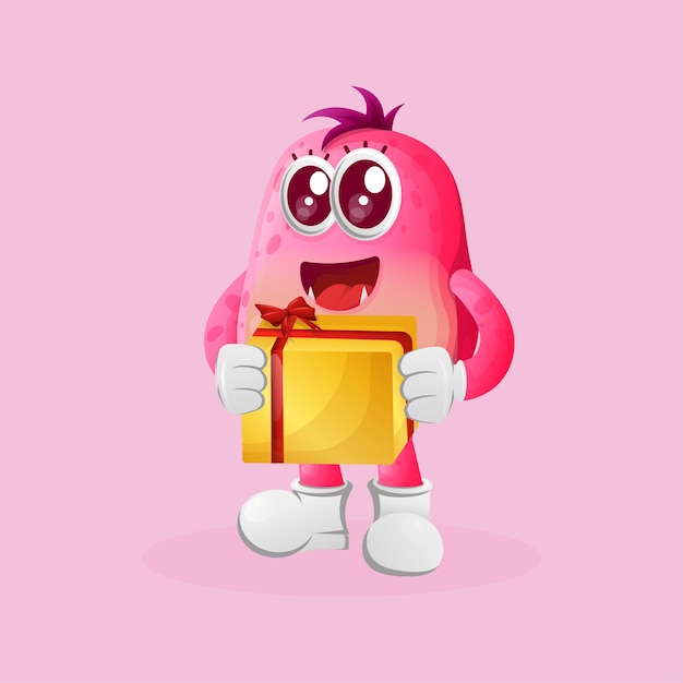 Vector cute pink monster holding gift box