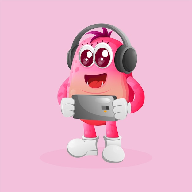 Cute pink monster playing game mobile wearing headphones