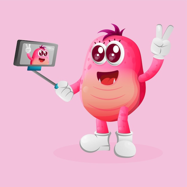 Cute pink monster takes a selfie with smartphone