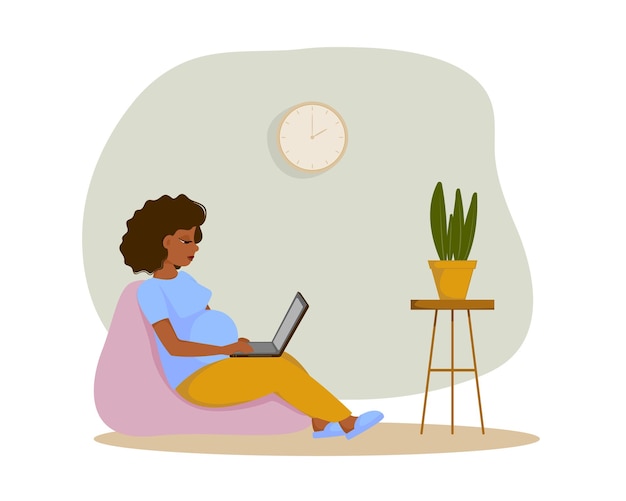 Cute pregnant woman working from home with laptop while sitting in a bag chair Freelance coworking