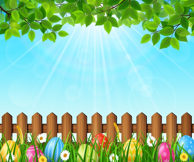 Easter background with colorful eggs in the grass