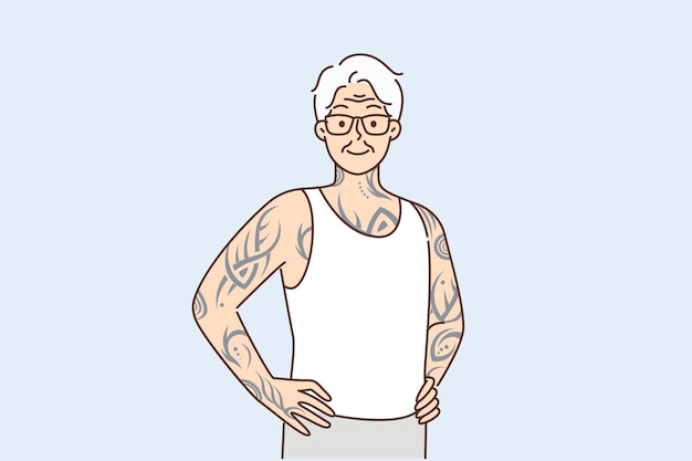 Elderly man with tattoos on arms and body stands with hands on belt proud good health in old age