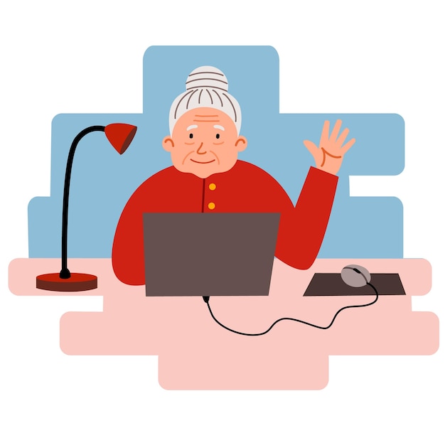 An elderly woman works at home at a computer. Cute granny is sitting at her desk and working.