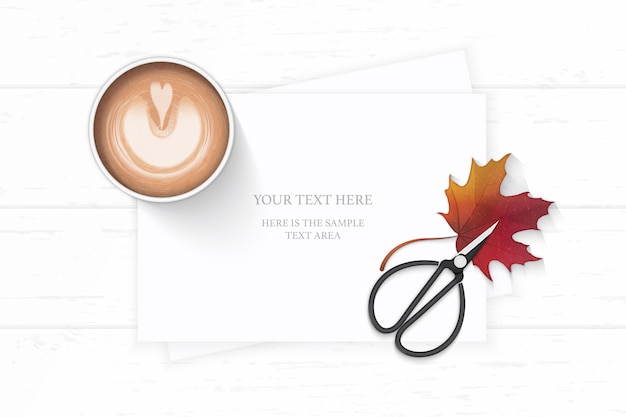 elegant paper with maple leaf coffee and vintage scissors on wooden background