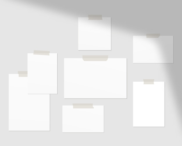 Empty sheets of white paper on the wall with shadow overlay.