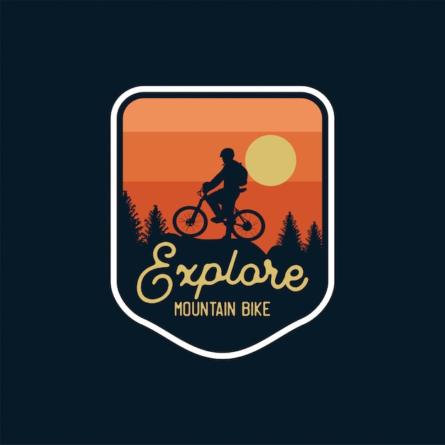 Explore mountain bike badge silhouette sunset background. logo patch