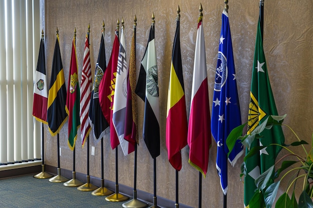 Vector flags from across the world a low angle shot of several international flags waving in the air