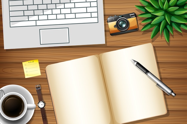 Flat lay of office work desk with office elements with green leaves